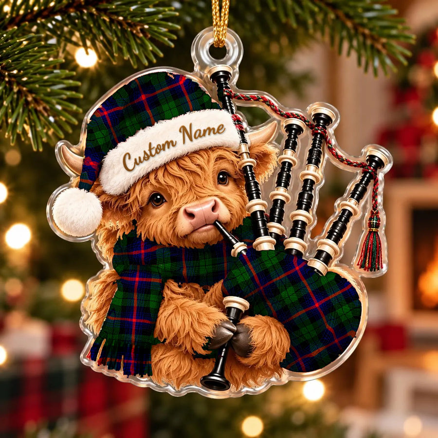 Acrylic Highland cow calf ornament playing the bagpipes, in a Urquhart Modern tartan Santa hat, scarf and pipe bag, with a custom name on the hat