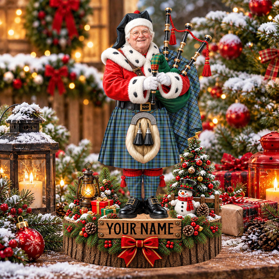 Personalized Christmas piper plaque in the Weir Ancient tartan, standing on a snowy log base with a name plaque