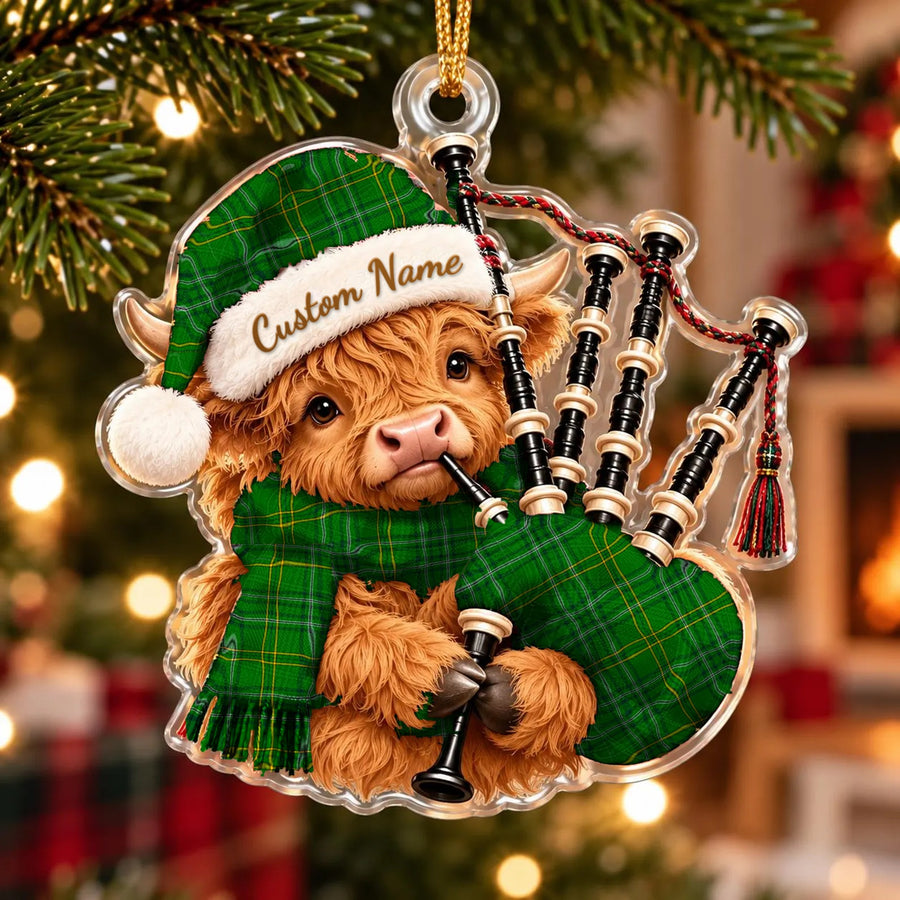Acrylic Highland cow calf ornament playing the bagpipes, in a Wexford County tartan Santa hat, scarf and pipe bag, with a custom name on the hat