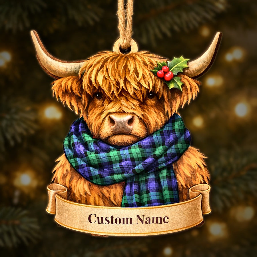 Wooden Highland cow Christmas ornament wearing a Blackwatch Modern tartan scarf, with a ribbon banner for a custom name