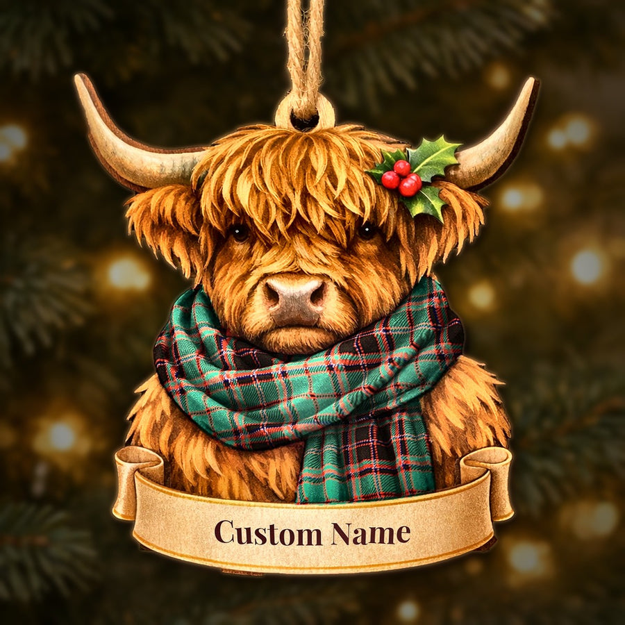 Wooden Highland cow Christmas ornament wearing a Buchan Ancient tartan scarf, with a ribbon banner for a custom name