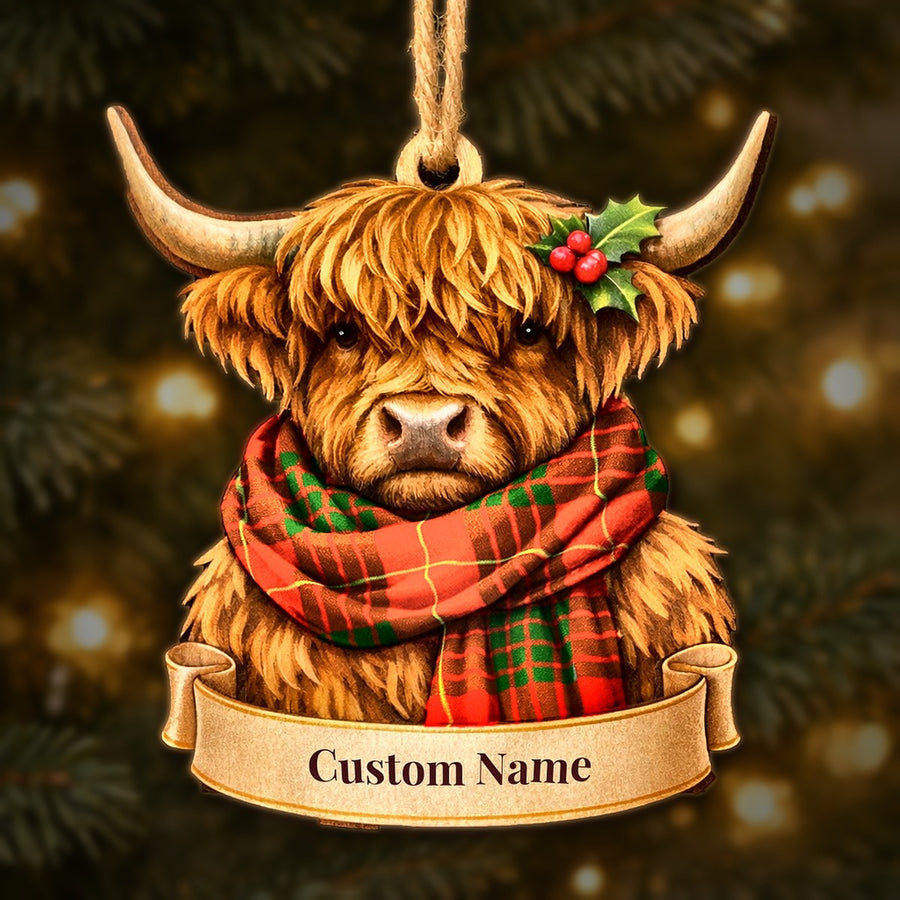 Wooden Highland cow Christmas ornament wearing a Cameron Modern tartan scarf, with a ribbon banner for a custom name