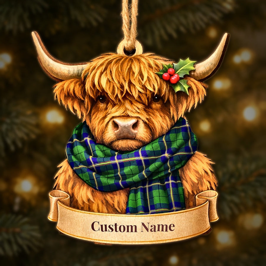 Wooden Highland cow Christmas ornament wearing a Carmichael Modern tartan scarf, with a ribbon banner for a custom name