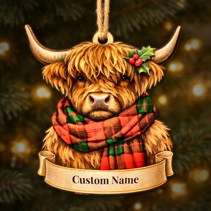 Wooden Highland cow Christmas ornament wearing a Dunbar Modern tartan scarf, with a ribbon banner for a custom name