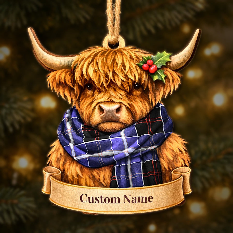 Wooden Highland cow Christmas ornament wearing a Dunlop Modern tartan scarf, with a ribbon banner for a custom name