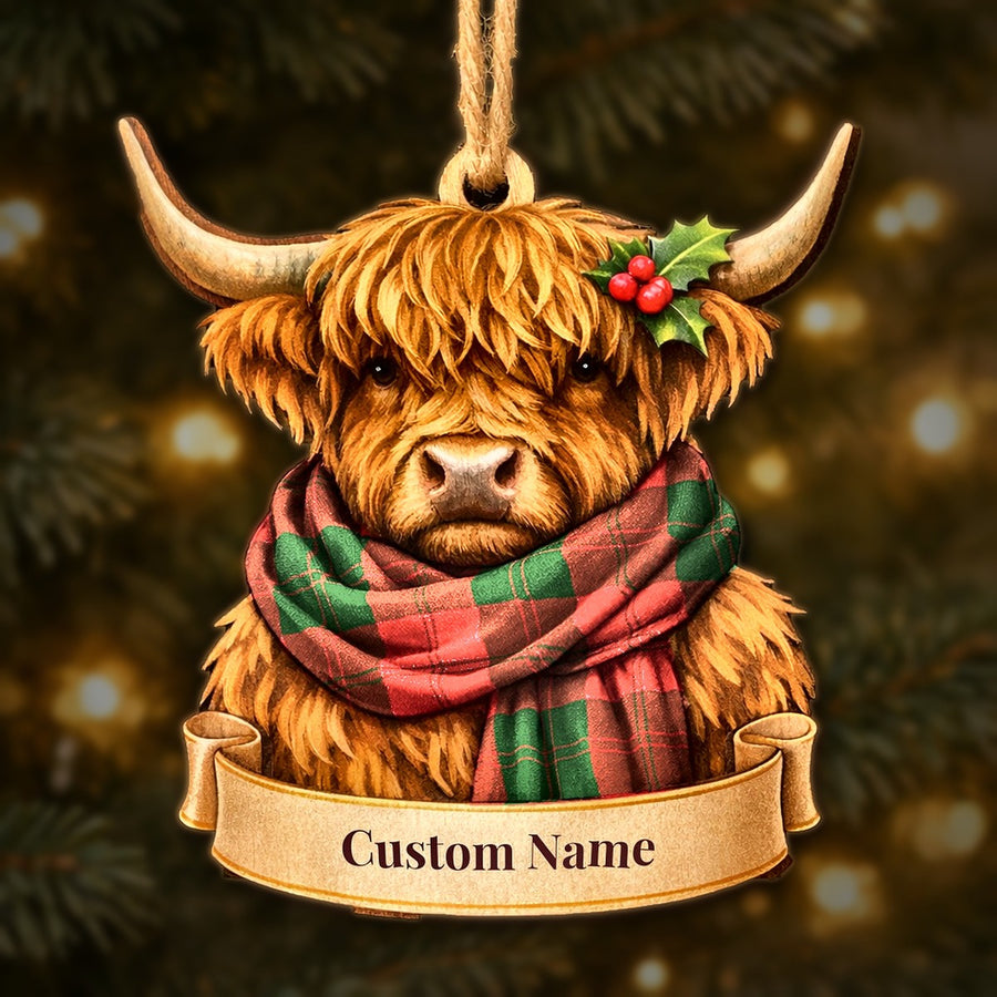 Wooden Highland cow Christmas ornament wearing a Erskine Modern tartan scarf, with a ribbon banner for a custom name