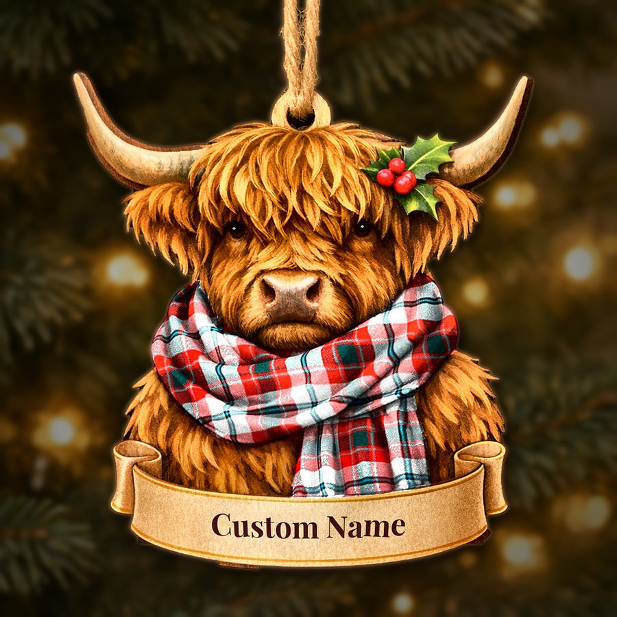 Wooden Highland cow Christmas ornament wearing a Glasgow District tartan scarf, with a ribbon banner for a custom name