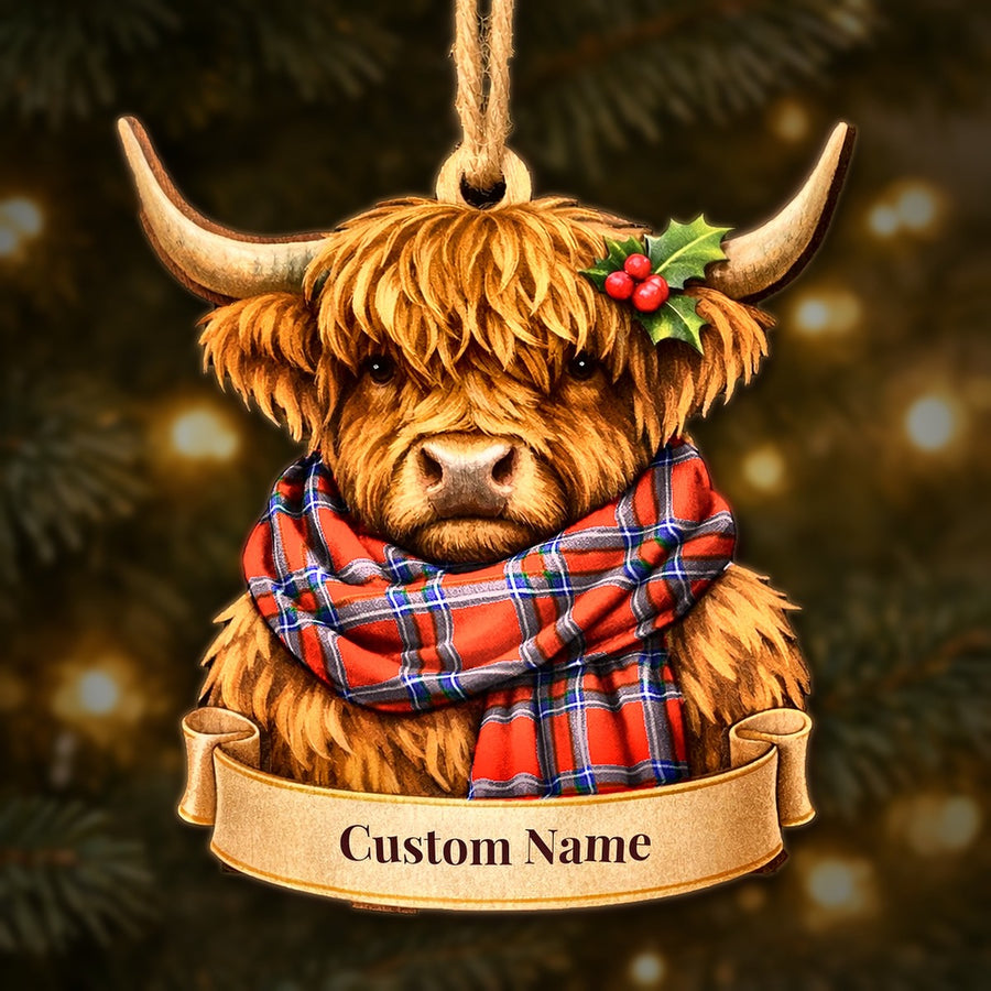 Wooden Highland cow Christmas ornament wearing a Inverness District tartan scarf, with a ribbon banner for a custom name