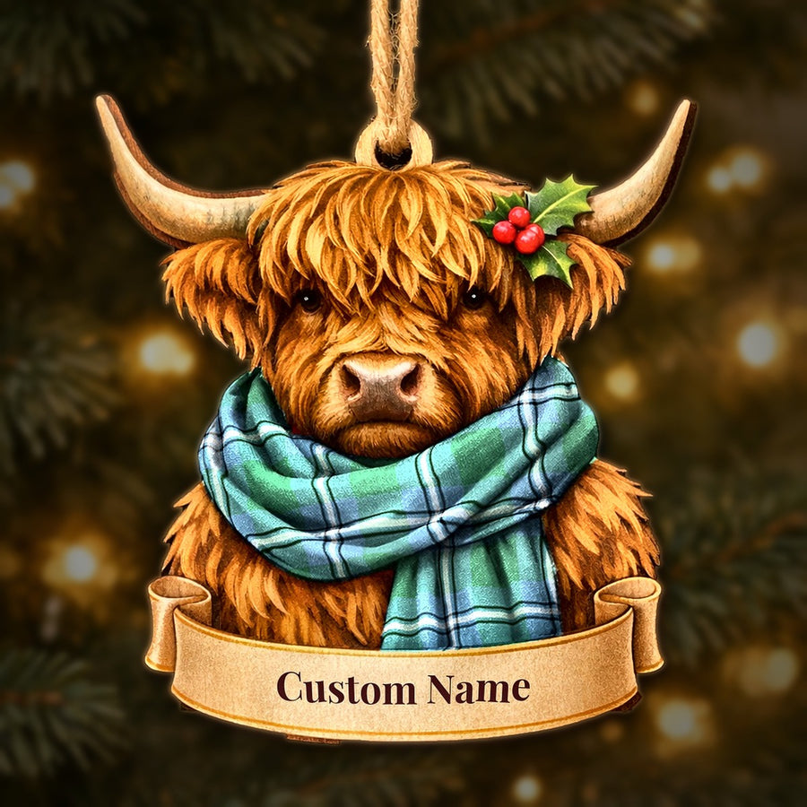 Wooden Highland cow Christmas ornament wearing a Irvine tartan scarf, with a ribbon banner for a custom name