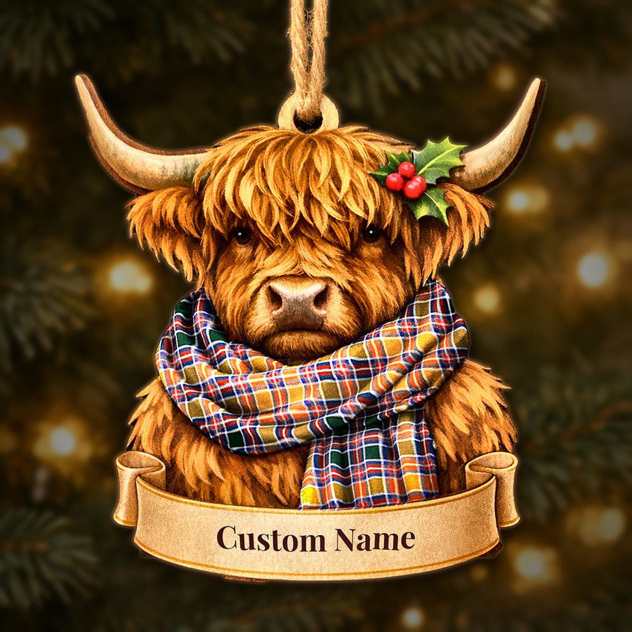 Wooden Highland cow Christmas ornament wearing a Jacobite tartan scarf, with a ribbon banner for a custom name