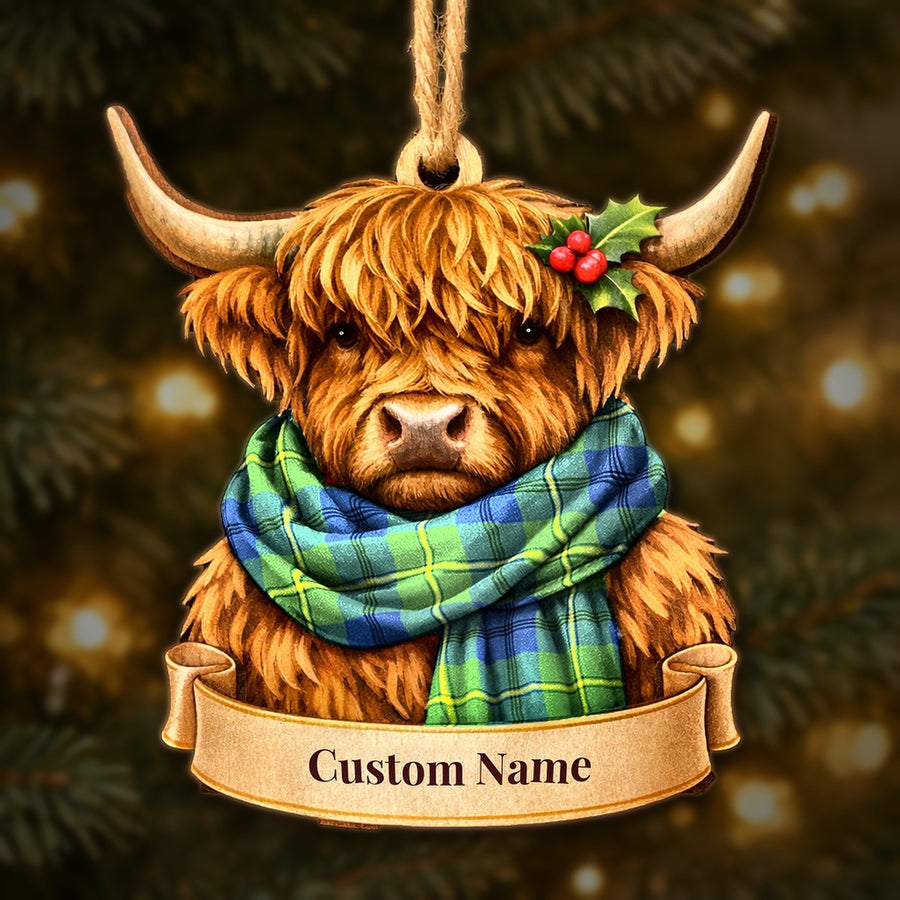 Wooden Highland cow Christmas ornament wearing a Johnston Ancient tartan scarf, with a ribbon banner for a custom name