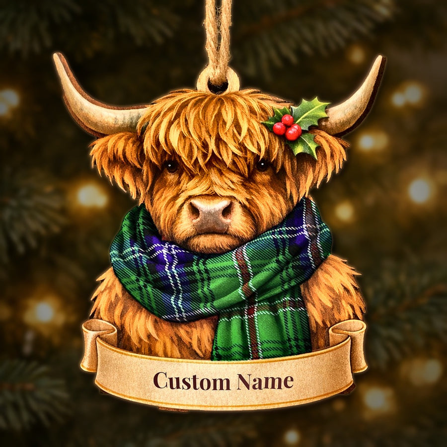 Wooden Highland cow Christmas ornament wearing a Kirby tartan scarf, with a ribbon banner for a custom name