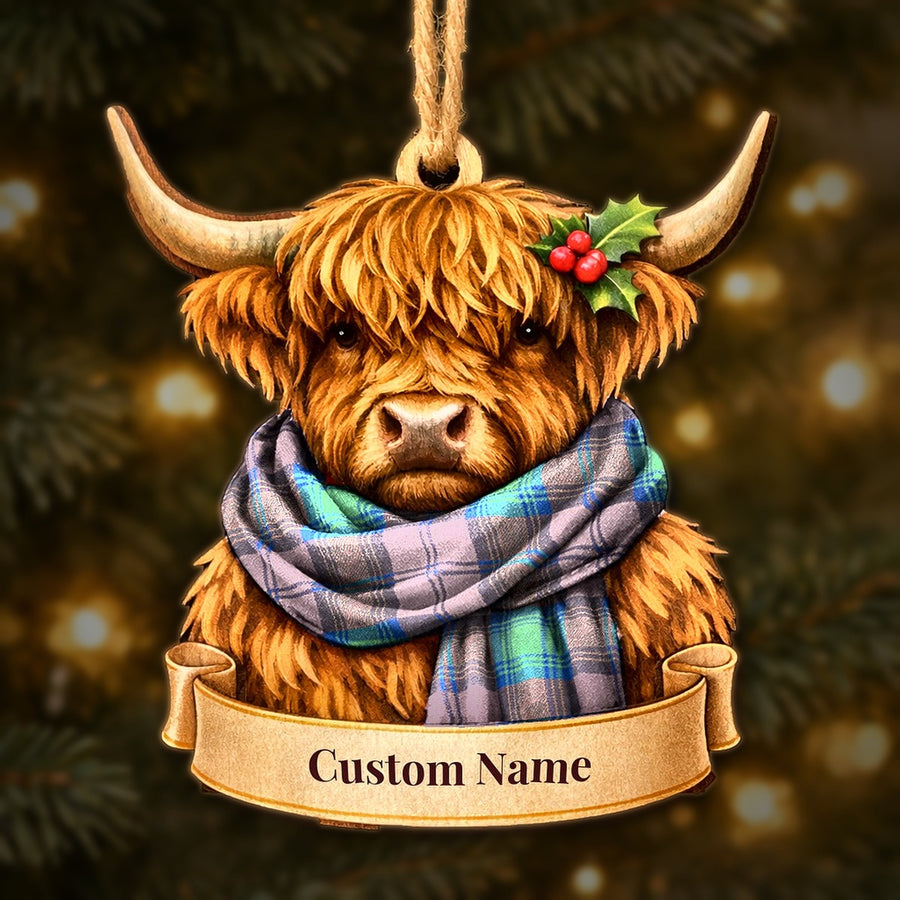 Wooden Highland cow Christmas ornament wearing a Lindsay Ancient tartan scarf, with a ribbon banner for a custom name