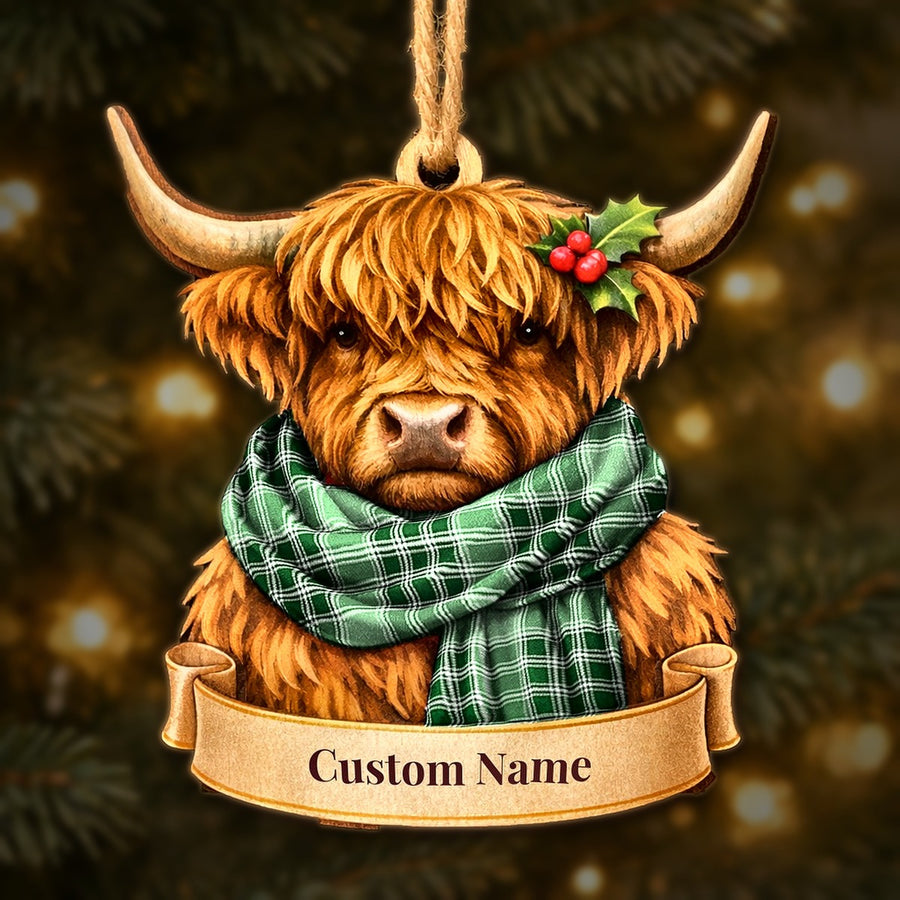 Wooden Highland cow Christmas ornament wearing a MacDonald Lord of the Isles Hunting tartan scarf, with a ribbon banner for a custom name