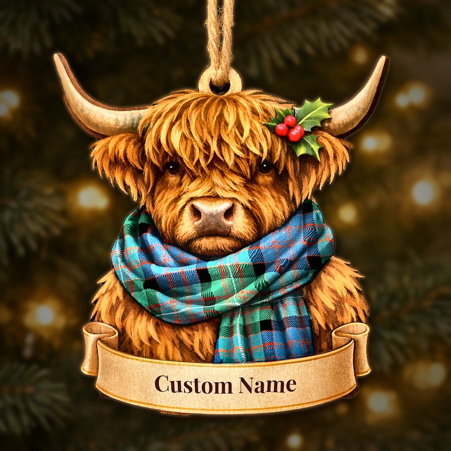 Wooden Highland cow Christmas ornament wearing a MacDonnell of Glengarry Ancient tartan scarf, with a ribbon banner for a custom name