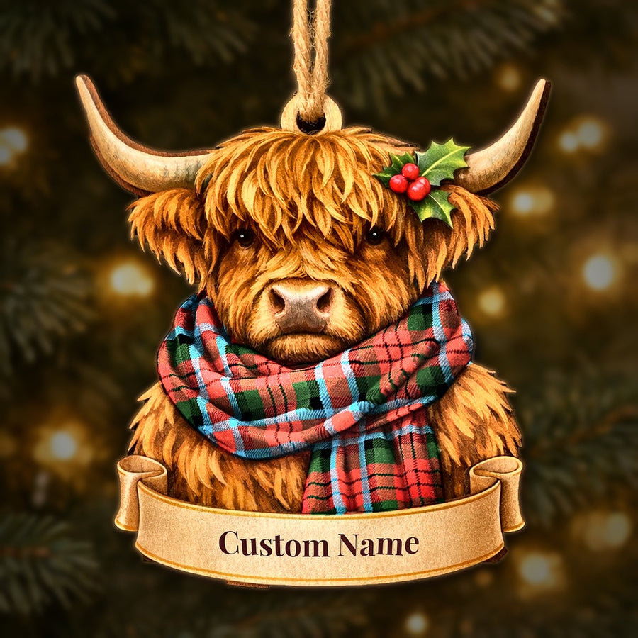 Wooden Highland cow Christmas ornament wearing a MacDuff Modern tartan scarf, with a ribbon banner for a custom name