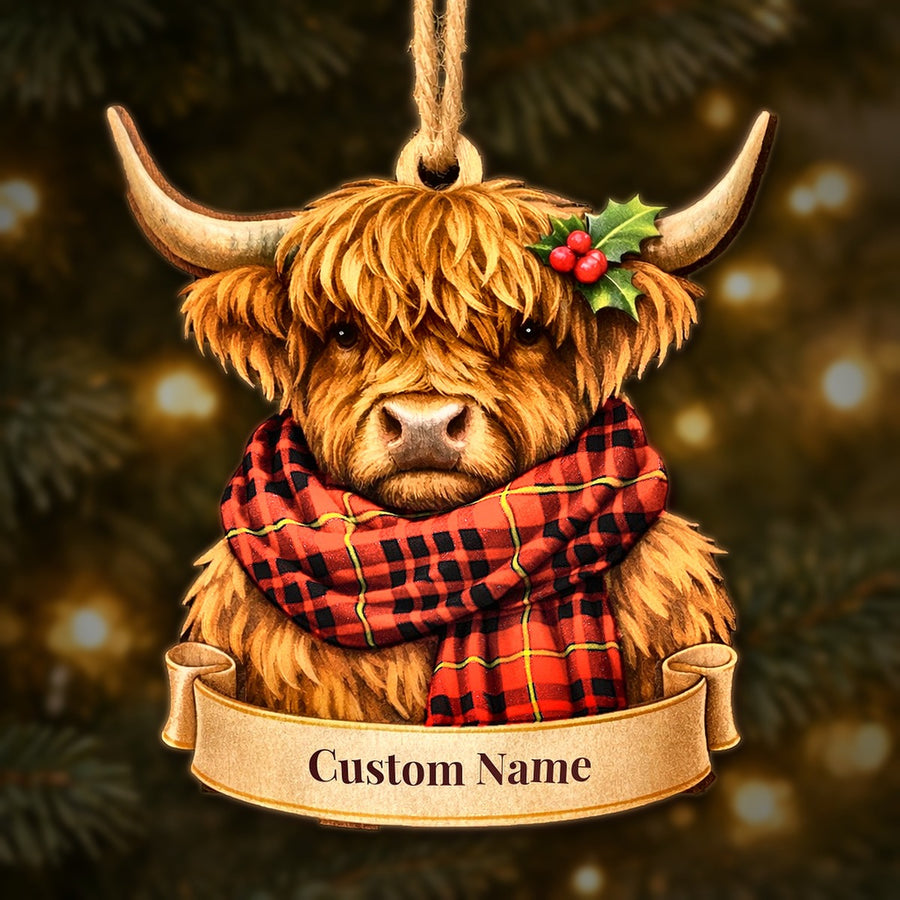 Wooden Highland cow Christmas ornament wearing a MacIan tartan scarf, with a ribbon banner for a custom name