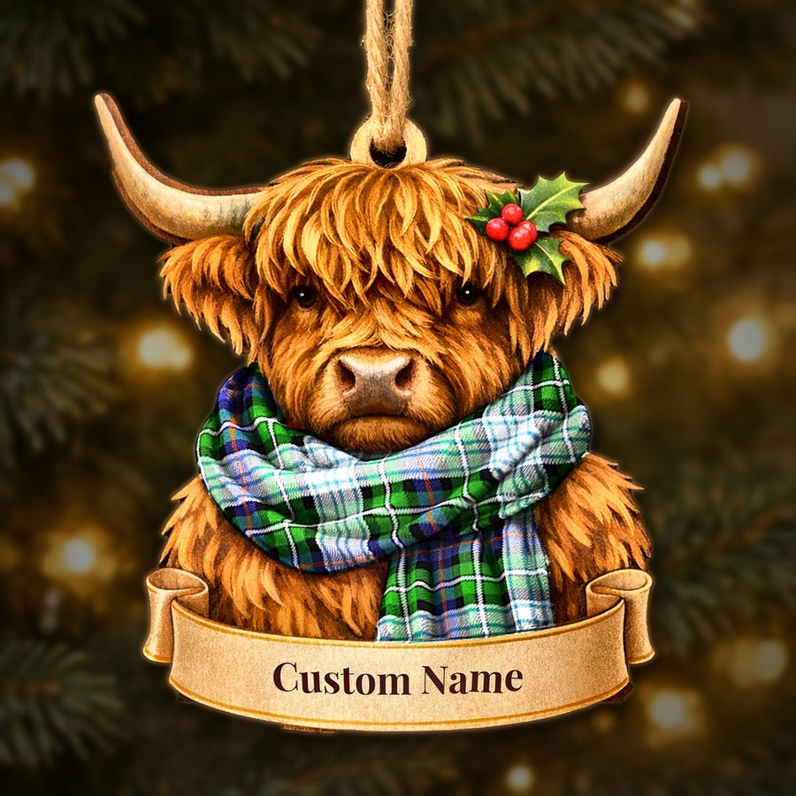 Wooden Highland cow Christmas ornament wearing a MacKenzie Dress Modern tartan scarf, with a ribbon banner for a custom name