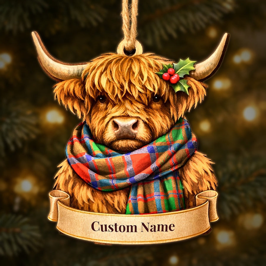 Wooden Highland cow Christmas ornament wearing a MacKintosh Modern tartan scarf, with a ribbon banner for a custom name