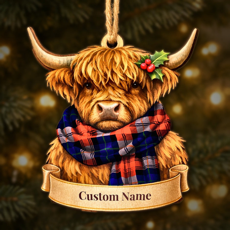 Wooden Highland cow Christmas ornament wearing a MacLachlan Modern tartan scarf, with a ribbon banner for a custom name