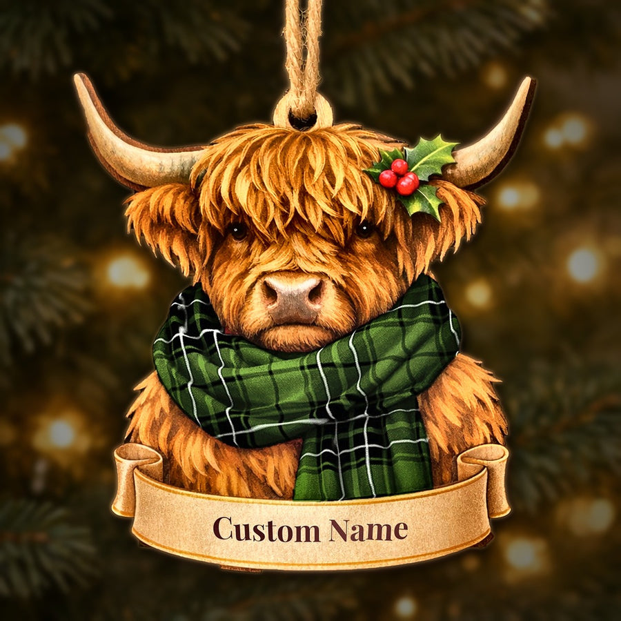 Wooden Highland cow Christmas ornament wearing a MacLean Hunting tartan scarf, with a ribbon banner for a custom name