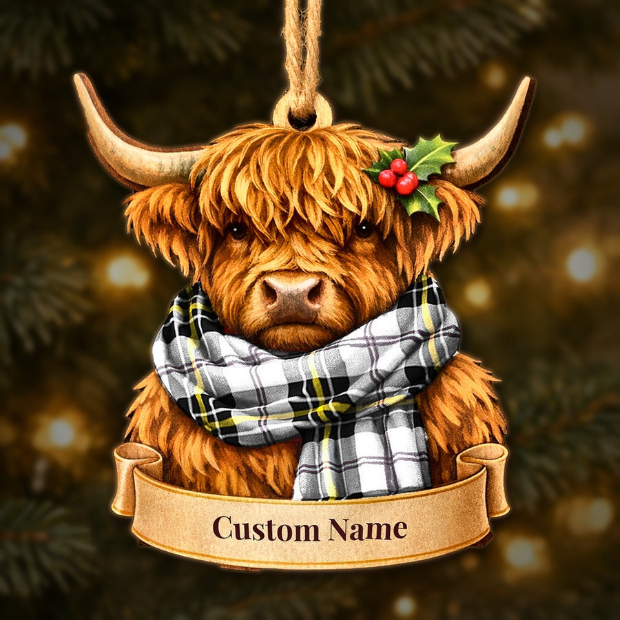 Wooden Highland cow Christmas ornament wearing a MacPherson Dress Modern tartan scarf, with a ribbon banner for a custom name