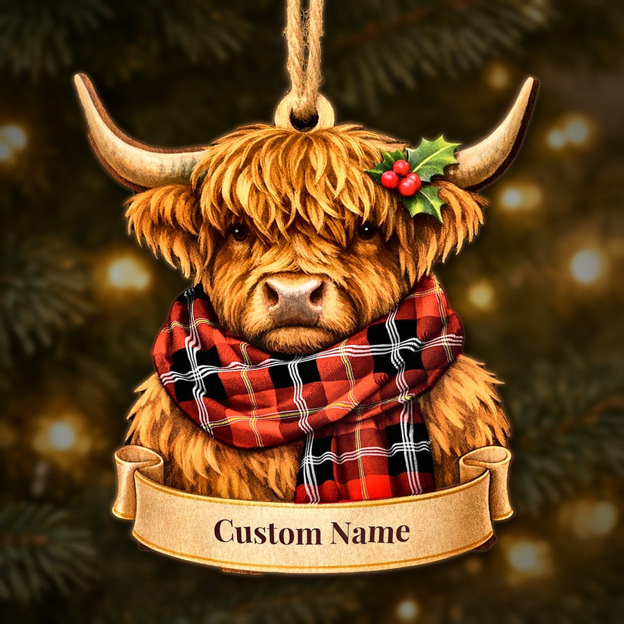 Wooden Highland cow Christmas ornament wearing a Marjoribanks tartan scarf, with a ribbon banner for a custom name