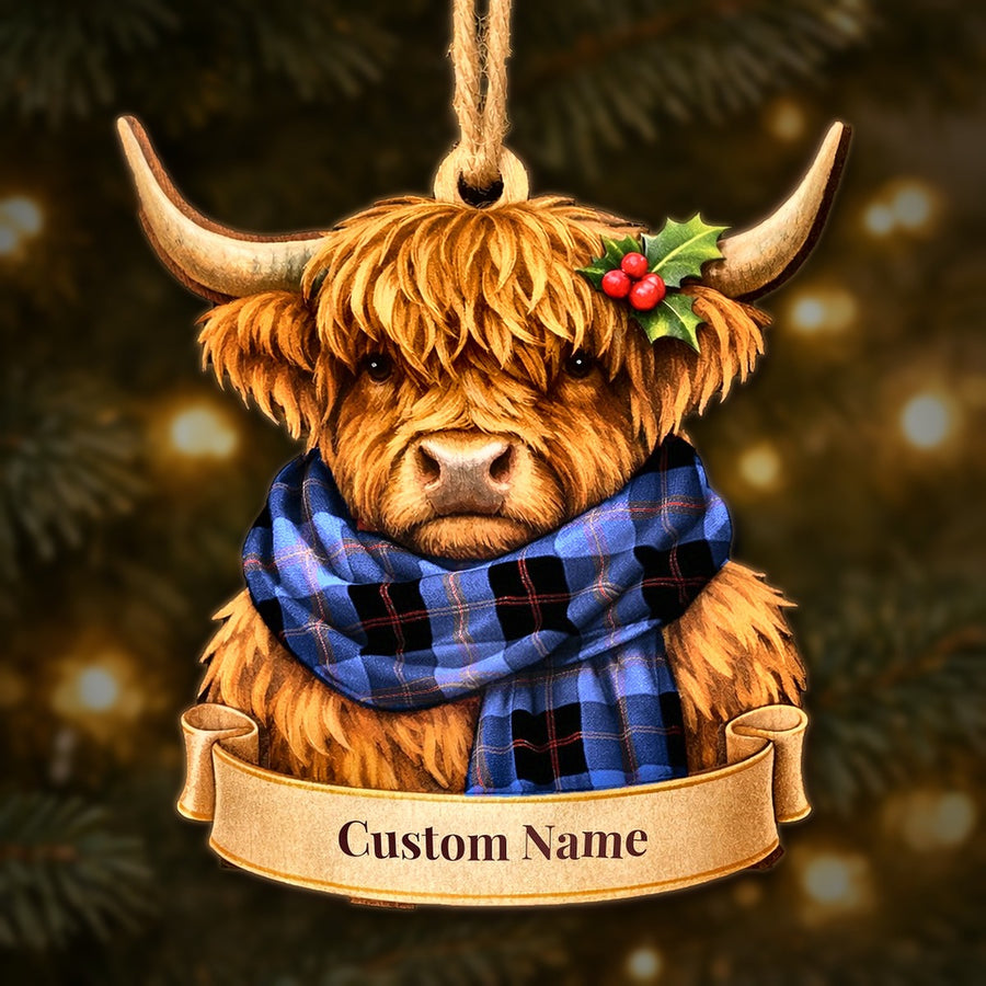 Wooden Highland cow Christmas ornament wearing a Maule tartan scarf, with a ribbon banner for a custom name