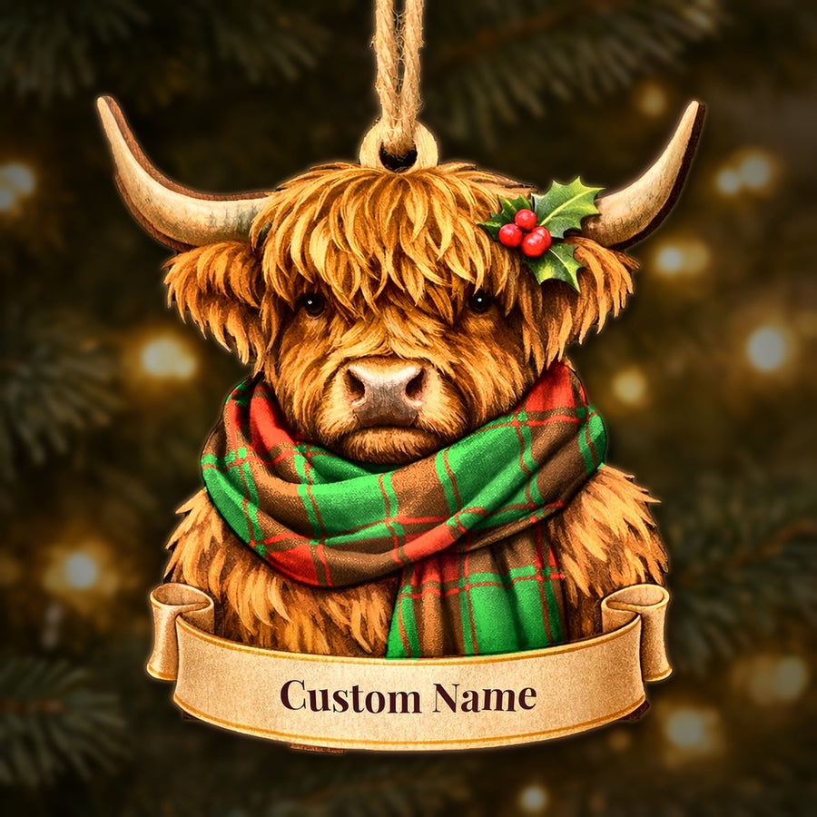 Wooden Highland cow Christmas ornament wearing a Middleton Modern tartan scarf, with a ribbon banner for a custom name