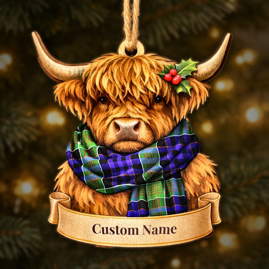 Wooden Highland cow Christmas ornament wearing a Newman tartan scarf, with a ribbon banner for a custom name