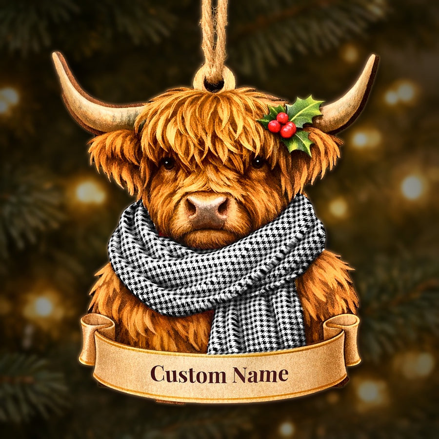 Wooden Highland cow Christmas ornament wearing a Shepherd tartan scarf, with a ribbon banner for a custom name
