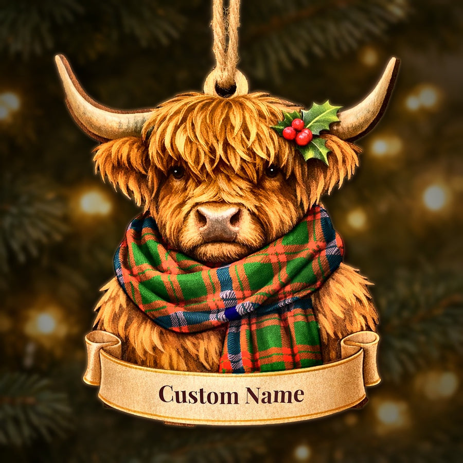Wooden Highland cow Christmas ornament wearing a Skene Modern tartan scarf, with a ribbon banner for a custom name