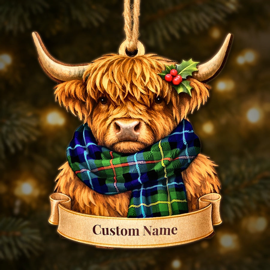 Wooden Highland cow Christmas ornament wearing a Smith Modern tartan scarf, with a ribbon banner for a custom name