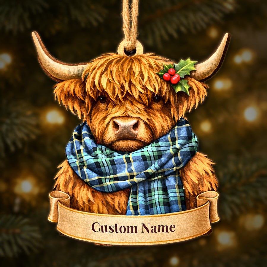 Wooden Highland cow Christmas ornament wearing a Weir Ancient tartan scarf, with a ribbon banner for a custom name