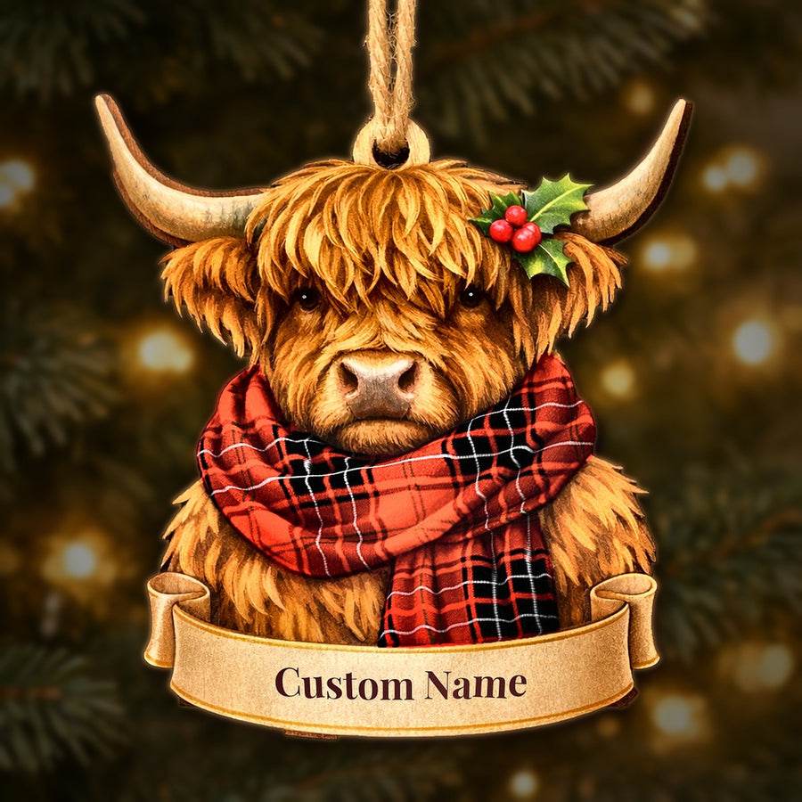 Wooden Highland cow Christmas ornament wearing a Wemyss Modern tartan scarf, with a ribbon banner for a custom name