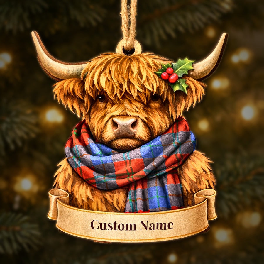 Wooden Highland cow Christmas ornament wearing a Witherspoon tartan scarf, with a ribbon banner for a custom name